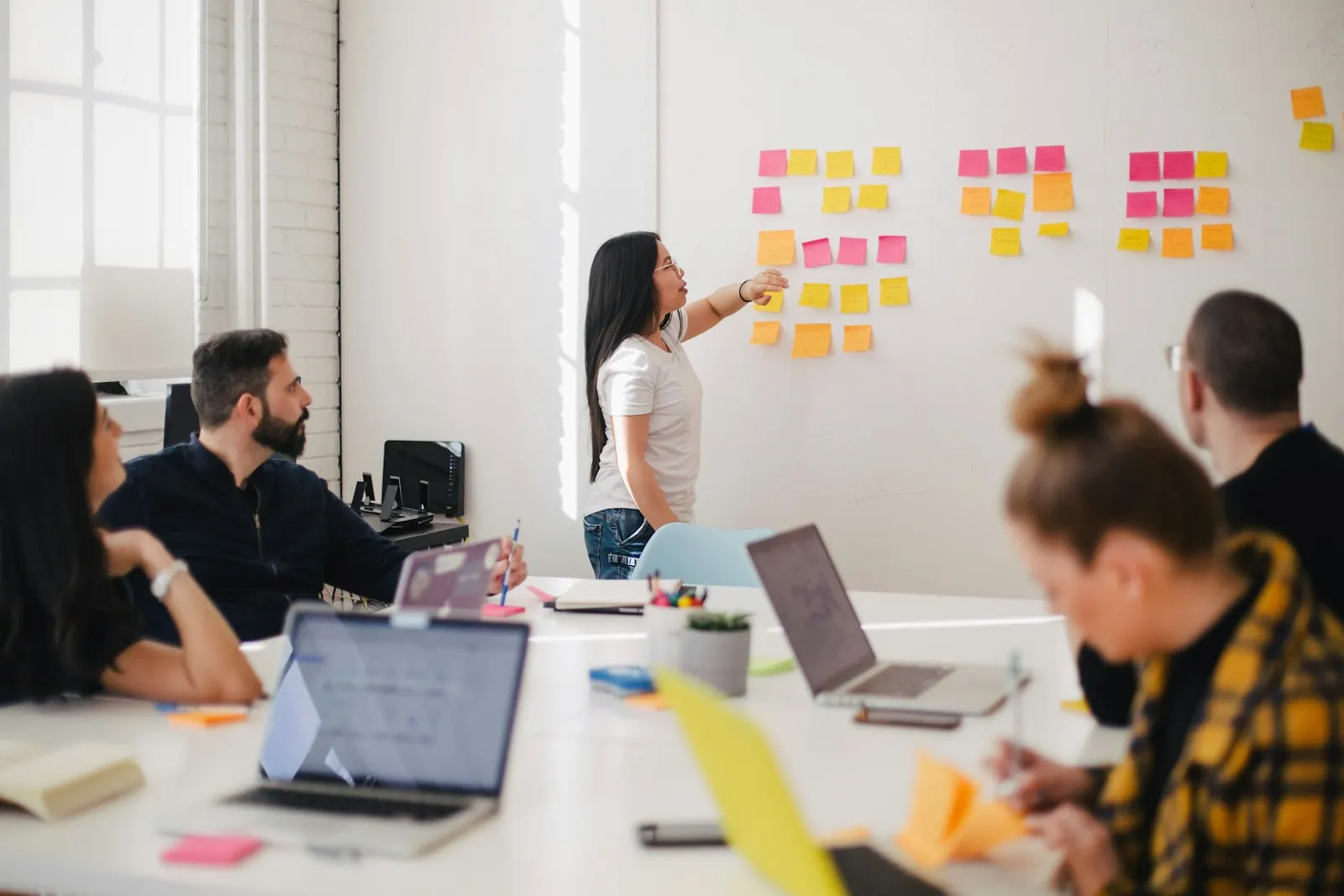 A team planning a project together, with sticky notes on the wall